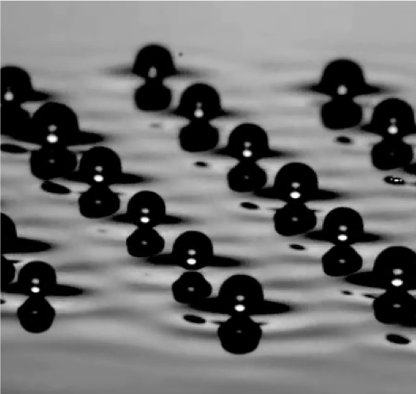 Floating spheres on a rippled water surface illustrating wave propagation
